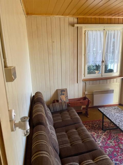Alter Wohnbereich mit Sofa und Holzverkleidung