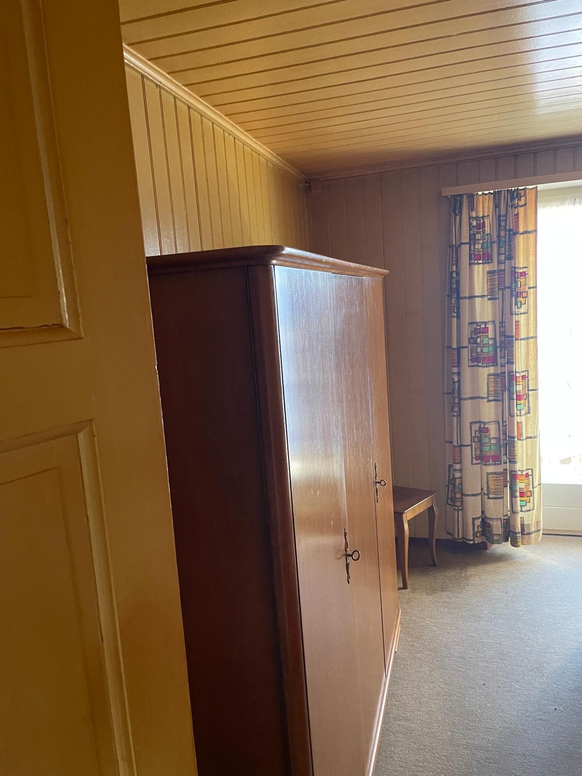 Altes Zimmer mit Fenster und Vorhang